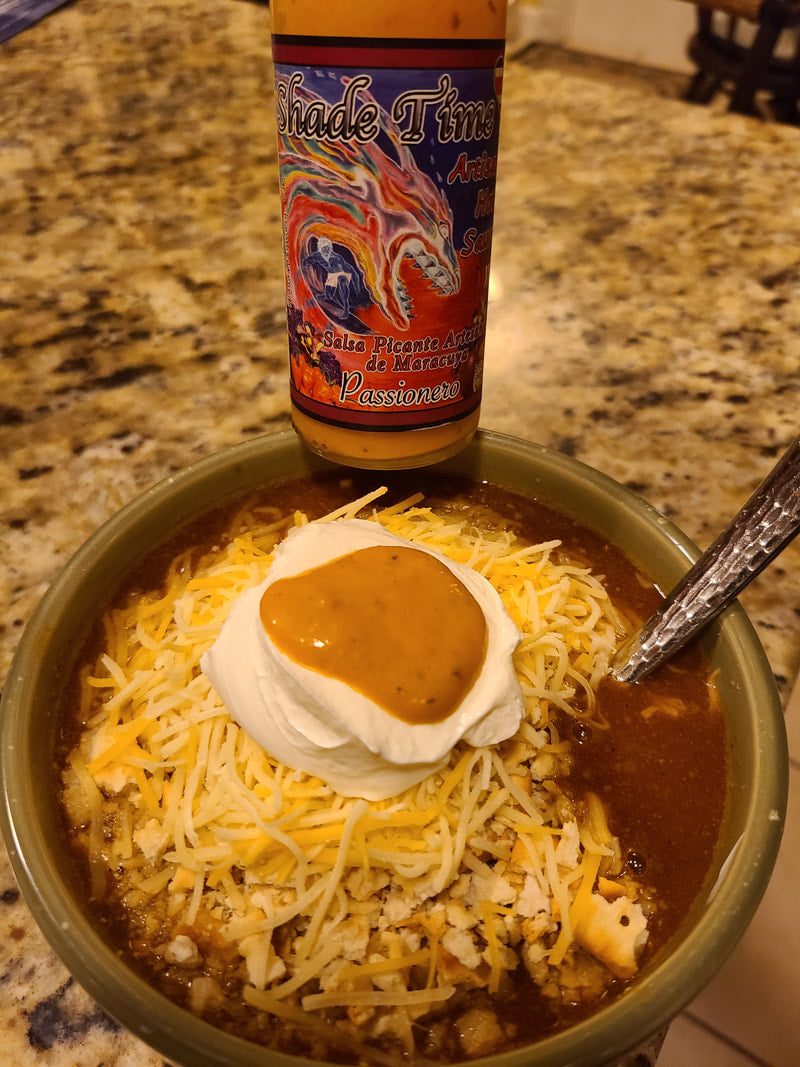 "Bowl of chili with Shade Time Passionero hot sauce"