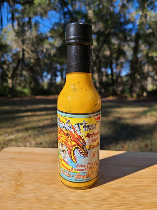 Piña Ginger hot sauce bottle with pineapple and ginger root